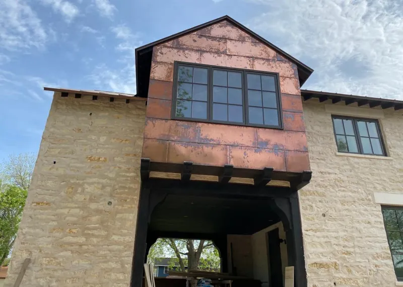 Copper metal panel facade on a stone building for Skylight Installation in Clarksville